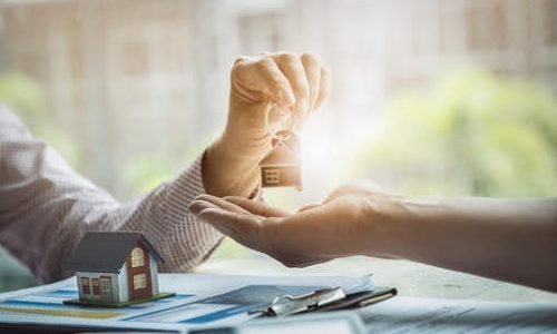 Real estate agents agree to buy a home and give keys to clients at their agency's offices. agreement and contract concept.